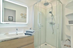 un baño con ducha y lavabo en L'Amanyn - Appartement proche plage, en Dinard 4 fotos más