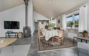 une salle à manger avec une table et une cheminée dans l'établissement Pet Friendly Home In Vestervig With Sauna, à Vestervig