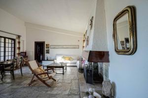 a living room with a fireplace and a mirror at Sonia Rustic Mansion - 5bd 30 Sec Walk To Beach in Áyioi Apóstoloi