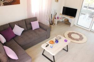 a living room with a couch and a table at Phaedra House For Relaxing Holidays Near Platanias in Vlakheronítissa