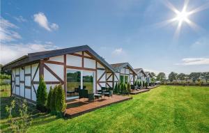 a row of houses on a grassy field at Amazing Home In Jaroslawiec With House A Panoramic View in Jarosławiec