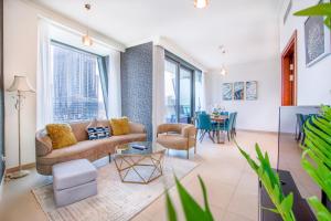 a living room with a couch and a table at Burj Vista 08 3BR Burj & Fountain View in Dubai