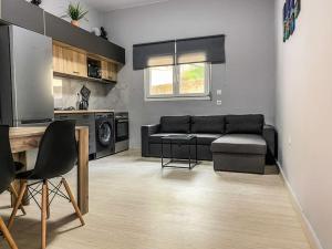 a living room with a couch and a table at Poseidon’s Bayview in Kitriaí