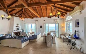 a living room with wooden ceilings and a table and chairs at Nice Home In Mantineia Messinia With Wifi in Kitriaí