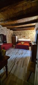 a bedroom with a bed and a stone wall at Kabula in Olbia +8 photos