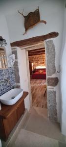 a bathroom with a sink and a room with a bedroom at Kabula in Olbia