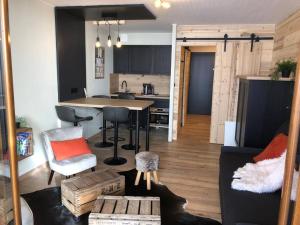 a kitchen and living room with a table and chairs at Studio Beethoven in Lans-en-Vercors