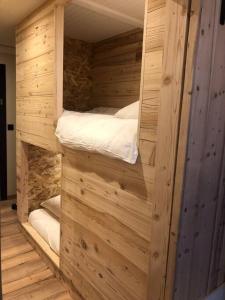 a wooden cabin with two bunk beds in it at Studio Beethoven in Lans-en-Vercors