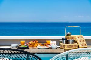 uma mesa com comida e bebidas numa varanda com o oceano em Izumo HOTEL THE CLIFF 