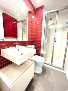 a bathroom with a toilet and a sink and a shower at Mirador de Calpe. Apartment with panoramic views. in Calpe
