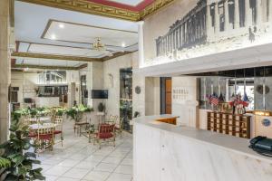 a lobby of a restaurant with a table and chairs at Marble House in Athens