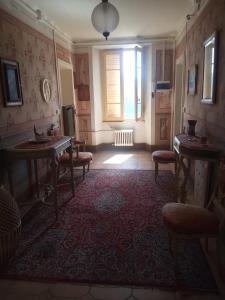 a room with chairs and a table and a window at Villa Giulia in Lura