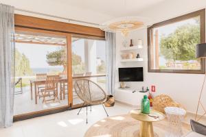 a living room with a view of the ocean at Villa Santa Maria with private pool and sea view in Afantou