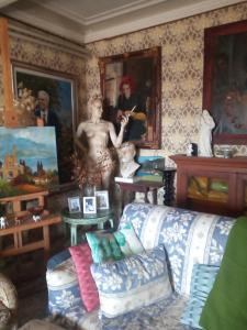 a living room with a couch and paintings on the wall at Villa Giulia in Lura