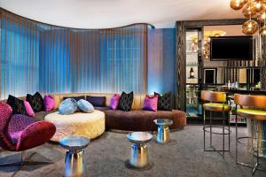 a living room with a couch and a bar at W Chicago - City Center in Chicago