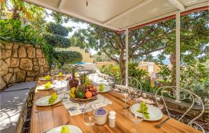 a wooden table with a bowl of fruit on it at Beautiful Home In Banjol With Sauna in Banjol