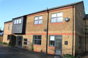 a brick building with a door on a street at Superb New Build 2 Bed Flat - 6 Ophelia Court in Epsom