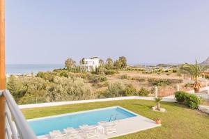 a villa with a swimming pool and a view of the ocean at Villa Santa Maria with private pool and sea view in Afantou