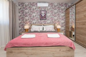 a bedroom with a large bed with two towels on it at Calypso - newly equiped, with separate entrance and parking in Supetar