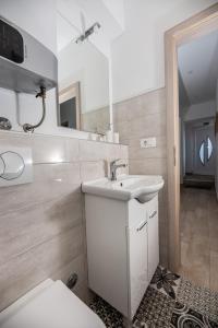 a bathroom with a sink and a toilet at Calypso - newly equiped, with separate entrance and parking in Supetar