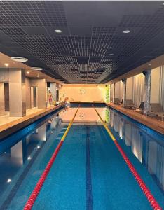 a large swimming pool with a row of lanes at Seaside Stories in Ķesterciems