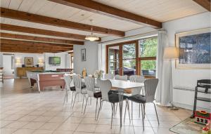 a dining room with a table and chairs at Four-Bedroom Holiday Home In Romo in Tagholm