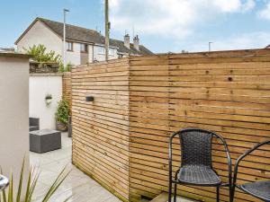 a chair sitting on a patio in front of a wooden fence at Apartment 1 - Ukc6766 in Arbroath