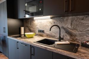 a kitchen with a sink and a counter top at Living Rain in Rain