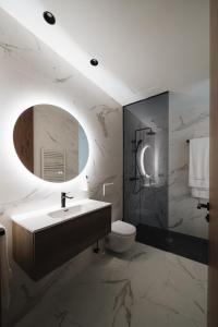 a bathroom with a sink and a toilet and a mirror at RÍOS SUITES Tudela in Tudela