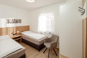 Letto o letti in una camera di Prälatenhof Wine & Apartments