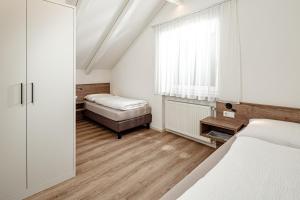 Letto o letti in una camera di Prälatenhof Wine & Apartments