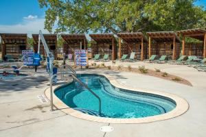 a swimming pool with a slide in a resort at Camp Fimfo Waco in Waco