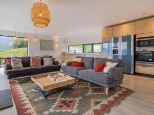 a living room with a couch and a table at Ardlearag in Garve