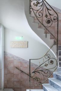 a staircase in a house with a wrought iron railing at Marble House in Athens