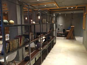 a room with shelves filled with books and balls at Rigas Boutique Hotel & Spa in Afitos