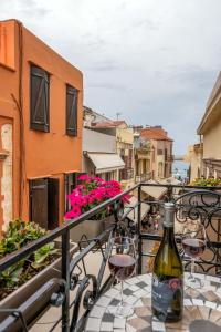 a bottle of wine sitting on a table on a balcony at Santa Elena Boutique Rooms in Chania Town