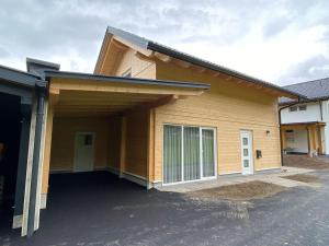 a house with a large garage in front of it at Felsenfest Cottage in Kötschach