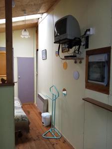 um quarto de hospital com uma televisão na parede em La cabane em Palogneux