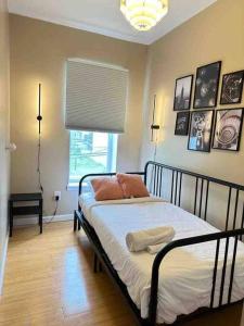a bedroom with a bed with pillows and a window at Liberty Dream - 20 min to NYC in Jersey City