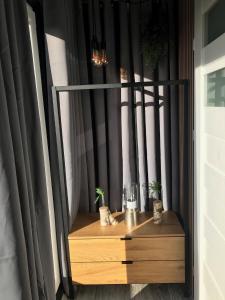 a room with a table with glasses and plants at Tinyhouse mit Alpen- Stadt- und Poolblick , WLAN in Passau