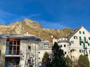 een groep gebouwen voor een berg bij 4 1/2 Room Maisonette Apartment with great views in Sils Maria