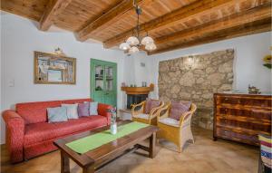 a living room with a couch and a table at Amazing Home In Draga Bascanska With Outdoor Swimming Pool in Draga Bašćanska