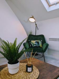 a living room with a green chair and a table at Cardiff apartment in Cardiff