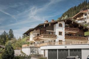a large house with a balcony on top of it at Apart. Mountainlovers in Hainzenberg