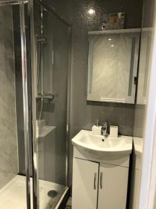 a bathroom with a sink and a shower at Furze Cottages in Buckinghamshire