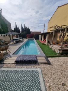 a swimming pool in the yard of a house at Le Cèdre 1830 Maison d'hôtes de charme et spa in Saint-Féliu-dʼAvall
