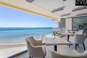 a dining room with a view of the beach at Melia Alicante in Alicante