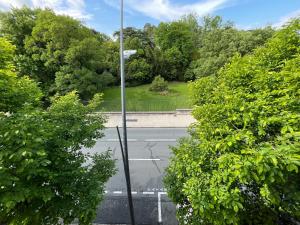 an empty street with trees and a street sign on a pole at Studio Le Cilaos, au cœur de Castres in Castres
