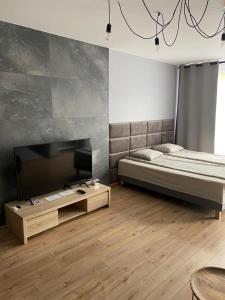 Postel nebo postele na pokoji v ubytování Apartamenty