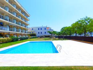 a swimming pool in front of a apartment building at GMID IMMO Apartment Mileni in Roses